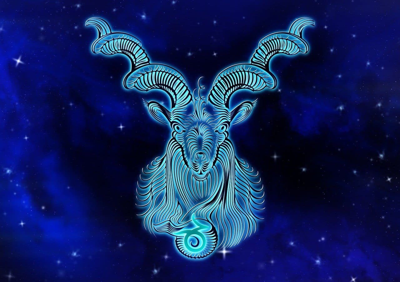 An artistic depiction of a glowing Capricorn symbol with intricate designs against a dark blue starry background, reminiscent of the elegance found in Cancer zodiac outfits.